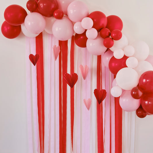 Red & Pink Balloon Arch Party Backdrop with Streamers and Paper Heart Decorations