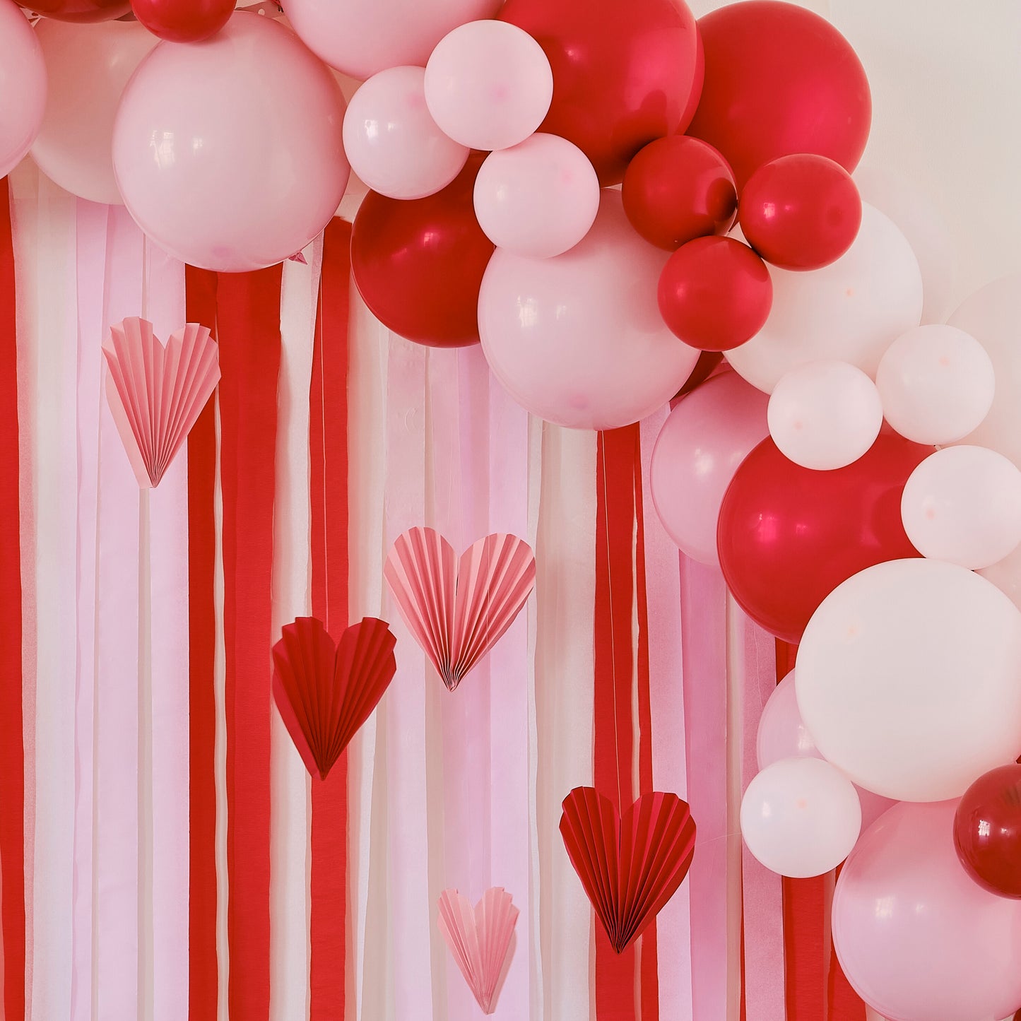 Red & Pink Balloon Arch Party Backdrop with Streamers and Paper Heart Decorations