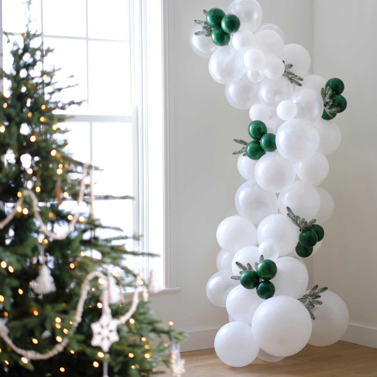 White & Dark Green Snowy Christmas Balloon Arch with Frosted Foliage