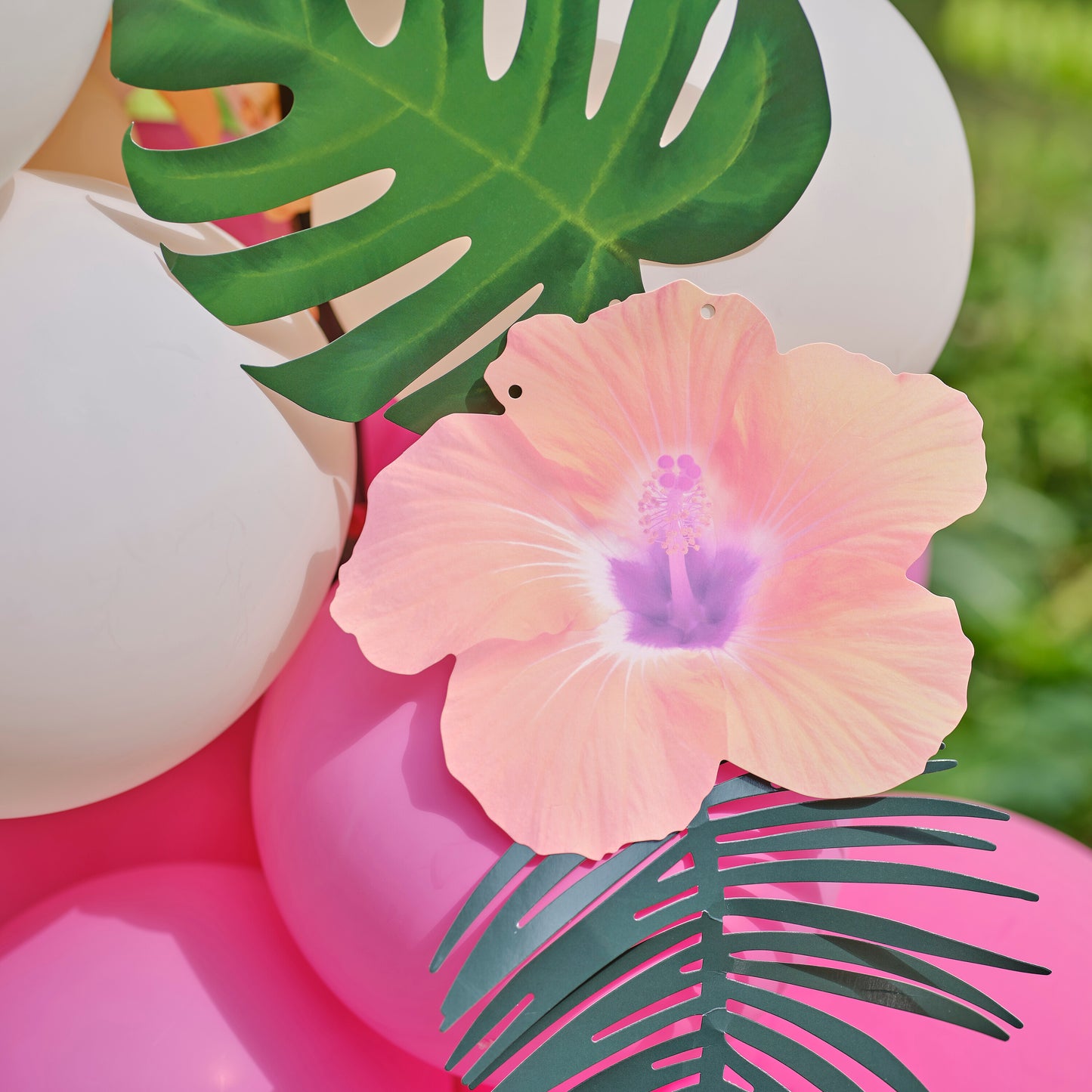 Blue, Pink, Green & Yellow Hawaiian Tiki Balloon Arch with Tropical Flowers and Foliage